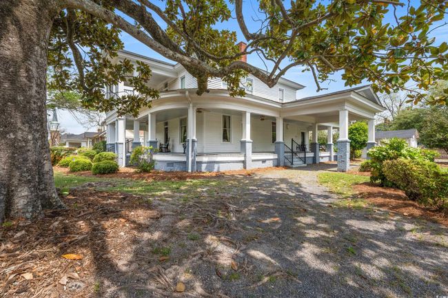 View of front of home with a porch, crawl space, a chimney, and driveway | Image 32