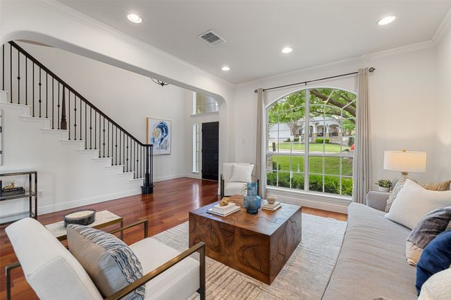 Living area featuring crown molding, stairway, wood finished floors, and recessed lighting | Image 9