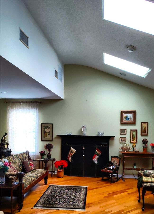 Living area featuring wood finished floors and high vaulted ceiling | Image 21