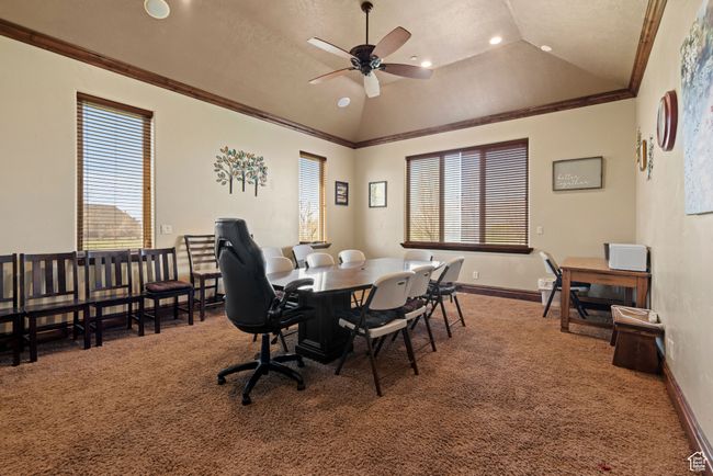 Dining space with a wealth of natural light, carpet, vaulted ceiling, and ceiling fan | Image 26