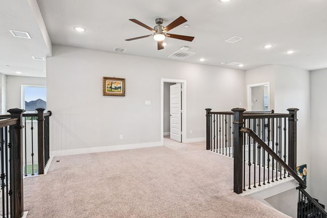 Hall with an upstairs landing, light colored carpet, and recessed lighting | Image 20