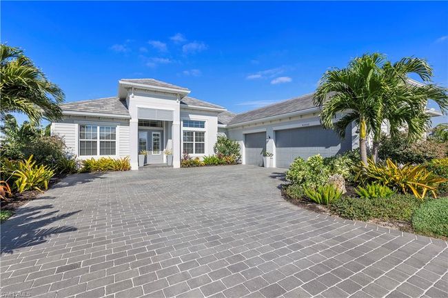 Prairie-style home featuring decorative driveway, an attached garage, and french doors | Image 16