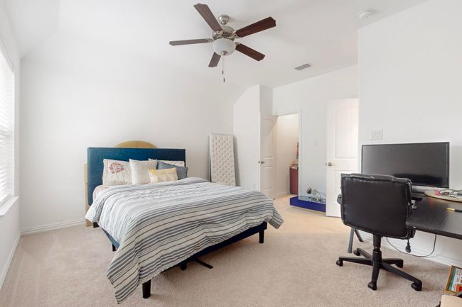Bedroom featuring light carpet, visible vents, and lofted ceiling | Image 29