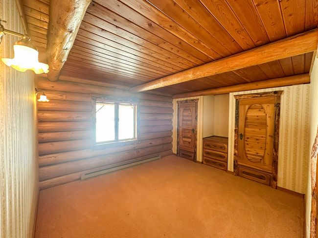 Bonus room with wood ceiling, baseboard heating, carpet floors, log walls, and beamed ceiling | Image 14