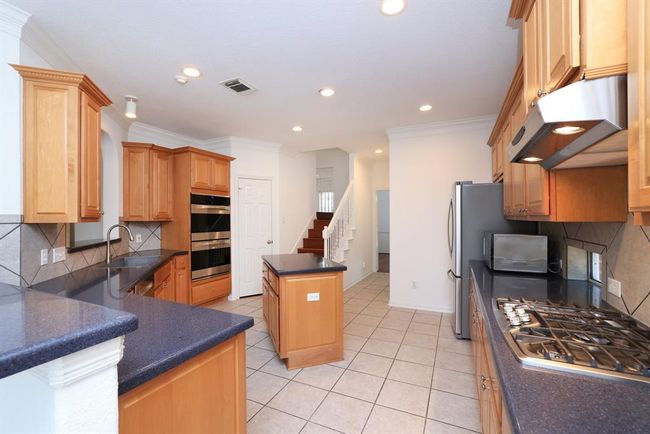 New extra large stainless sink and faucet, newer gas cooktop and upgraded double ovens. Quartz counters and newer refrigerator conveys with sale. | Image 15