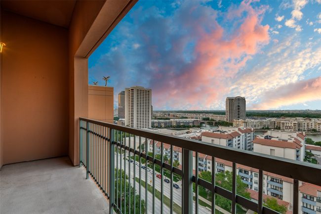 Balcony at dusk with a view of city | Image 12