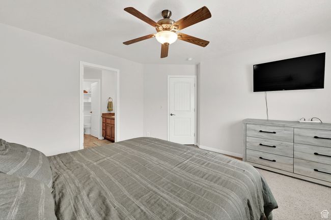 Bedroom with baseboards, ensuite bathroom, and a ceiling fan | Image 18