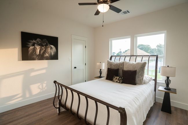 Bedroom with baseboards, dark wood-style floors, and a ceiling fan | Image 23