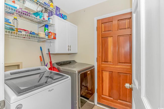Washroom featuring cabinet space and separate washer and dryer | Image 8