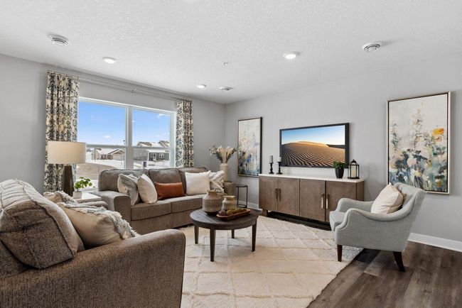 Another view of the wide-open main floor. Perfect for entertaining. Photo is of model home. Colors and options may vary. Ask Sales Agent for details. | Image 11