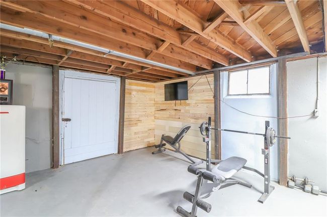 Exercise room featuring wood walls | Image 34