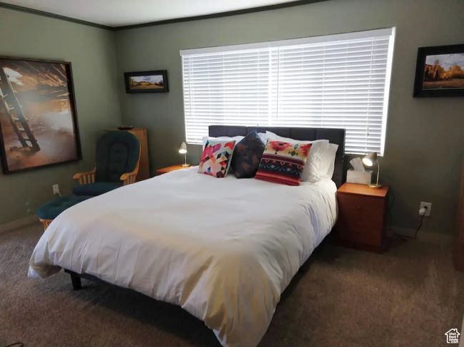 Carpeted bedroom with ornamental molding | Image 7