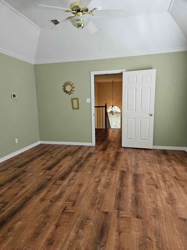 Additional living space with vaulted ceiling, wood finished floors, and a ceiling fan | Image 10