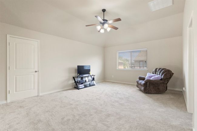 Unfurnished room with a ceiling fan, carpet flooring, lofted ceiling, and baseboards | Image 22