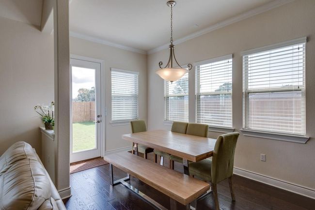 Dining area with baseboards, ornamental molding, and dark wood finished floors | Image 10