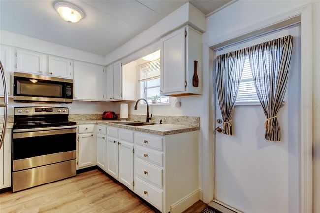 19. FULLY UPDATED Kitchen (9.2' x 8.9') w Kitchen Sink Window! HIGH QUALITY Stainless Appliances, White Cabinets, Gorgeous Counters. | Image 18