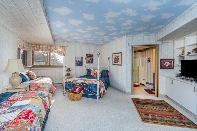 Bedroom with light colored carpet and baseboard heating | Image 35