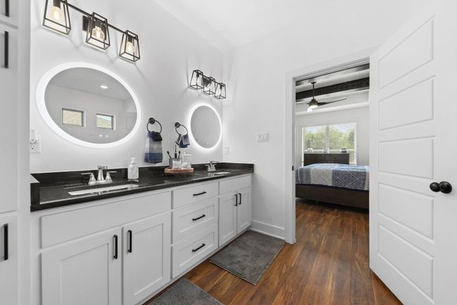 Ensuite bathroom with a sink, ceiling fan, double vanity, and wood finished floors | Image 21