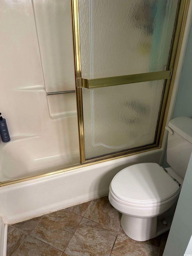 Bathroom featuring toilet and enclosed tub / shower combo | Image 24
