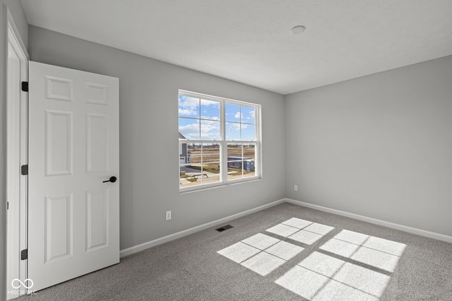 carpeted spare room featuring baseboards and visible vents | Image 11