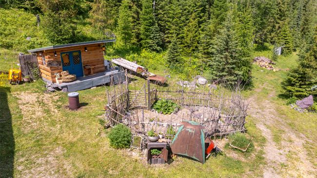 View of yard featuring a view of trees and an outdoor structure | Image 40