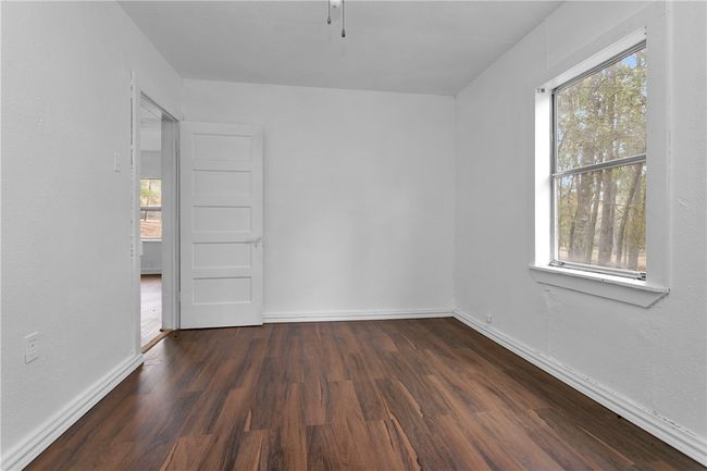 Unfurnished room featuring healthy amount of natural light and dark wood-type flooring | Image 27