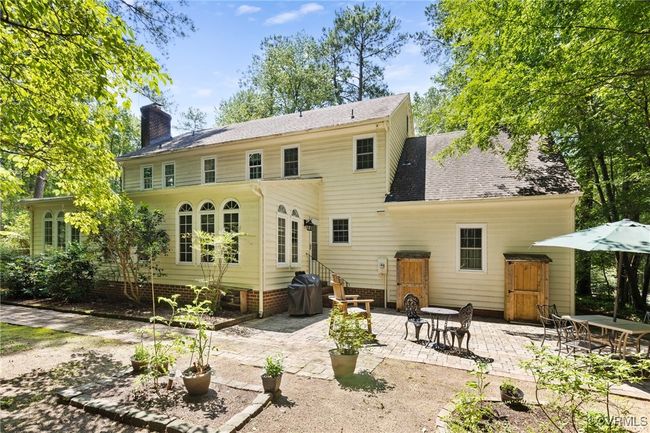 Back of house with entry steps, a patio area, and a chimney | Image 39