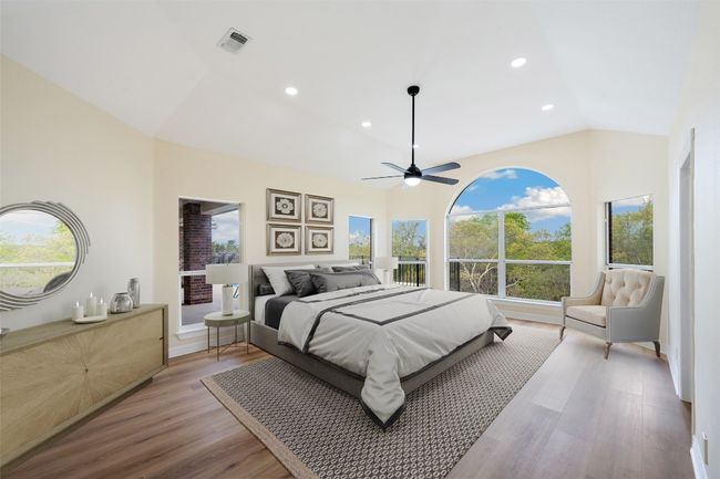 Bedroom featuring light wood-style floors, recessed lighting, visible vents, and vaulted ceiling | Image 20