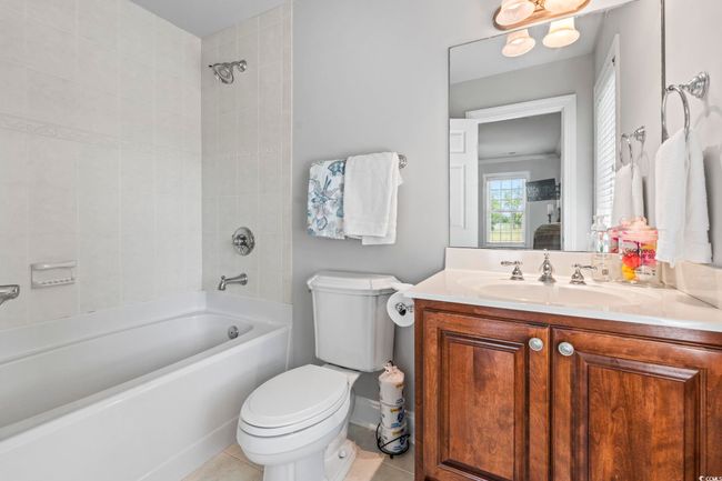 Bathroom featuring toilet, shower / washtub combination, vanity, and tile patterned floors | Image 18