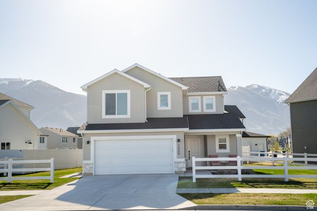 View of front of house with driveway, a mountain view, stucco siding, and fence | Image 32