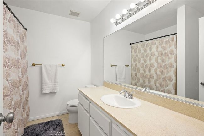 Upstairs: 1 full bathroom with shower in tub & additional storage space | Image 11