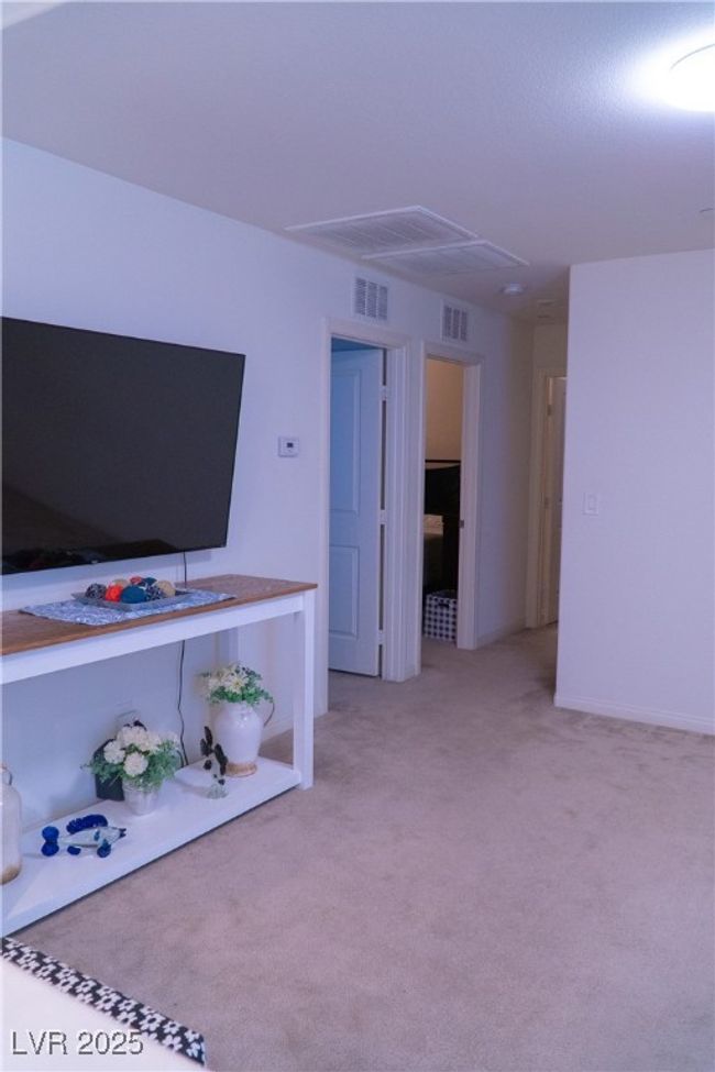 Unfurnished living room featuring light carpet and visible vents | Image 44