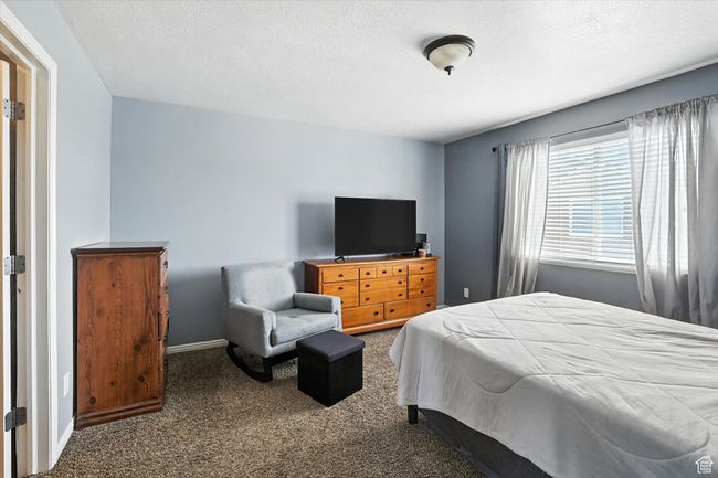 Bedroom with carpet floors and a textured ceiling | Image 17