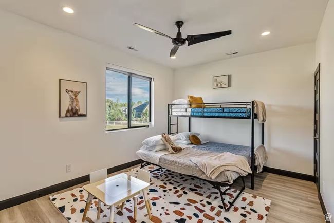 Bedroom with recessed lighting, wood finished floors, a ceiling fan, and baseboards | Image 50