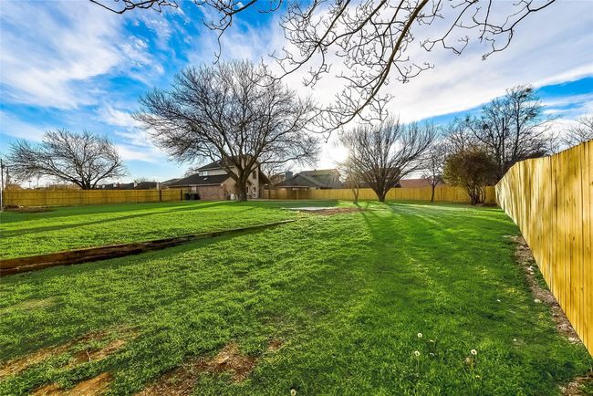 View of fenced backyard | Image 23