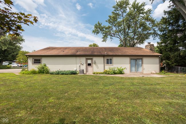 back of house featuring a yard, a patio, and a chimney | Image 36