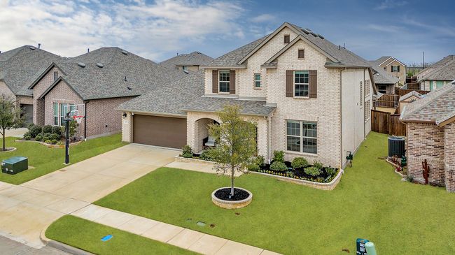 View of front of house featuring an attached garage, concrete driveway, brick siding, and a shingled roof | Image 31
