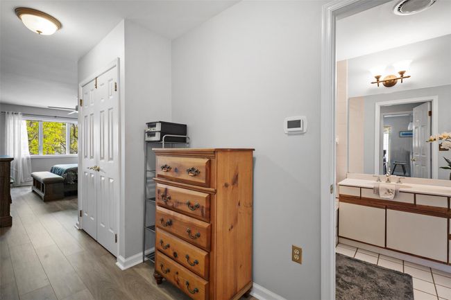 Corridor with a sink, wood finished floors, and baseboards | Image 14