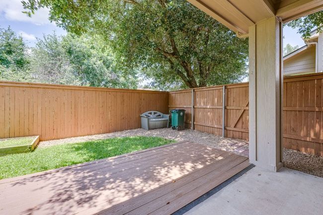 Wooden deck with a fenced backyard | Image 35