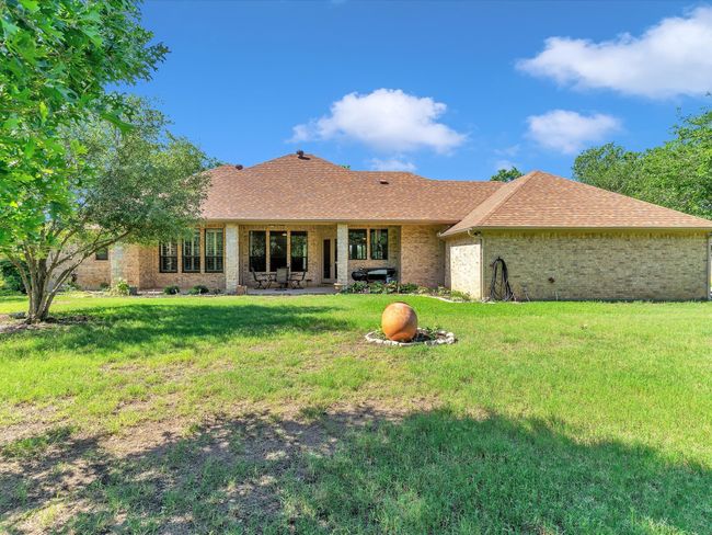 Back of house with roof with shingles, a patio area, brick siding, and a lawn | Image 34