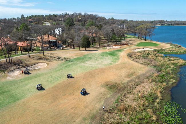 Drone / aerial view of a local golf course, a large body of water, and a tree filled landscape | Image 21