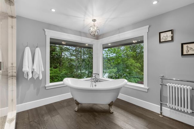 Full bath with radiator heating unit, baseboards, a freestanding tub, wood finished floors, and recessed lighting | Image 22