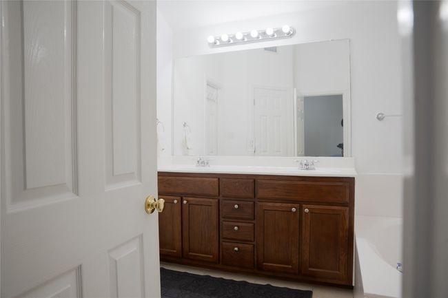 Bathroom with double vanity and a bath | Image 4