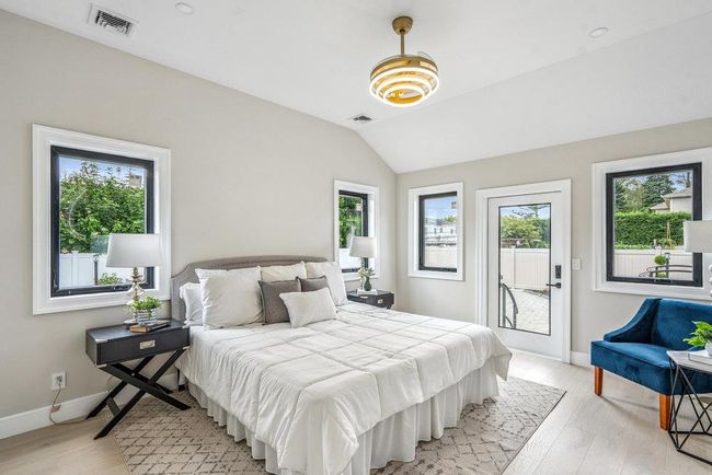 Sunlit Bedroom with vaulted ceiling and light Hardwood flooring, Recess Lighting, Walk-in Closets | Image 24