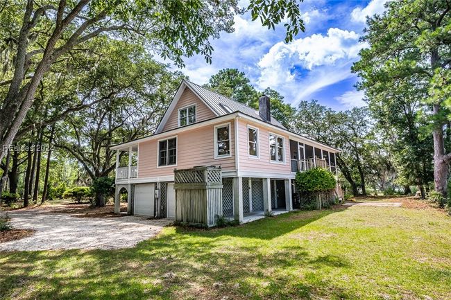 View of side of home featuring a garage and a lawn | Image 51