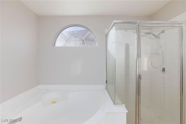 Bathroom featuring a stall shower and a garden tub | Image 30