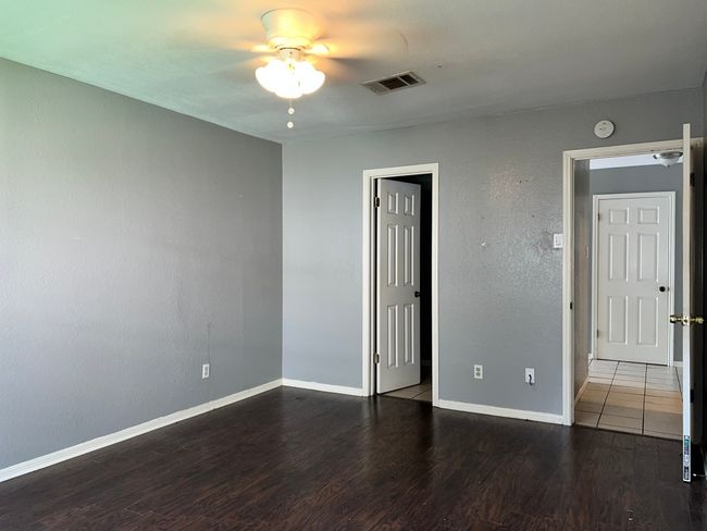Empty room with ceiling fan and wood finished floors | Image 10