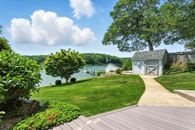 View of yard featuring a water view, a shed, and a dock | Image 4