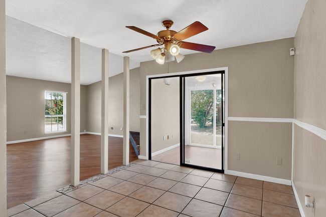 Empty room featuring ceiling fan and light wood-style flooring | Image 6