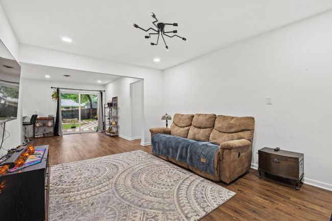 Living area featuring wood finished floors, recessed lighting, and baseboards | Image 17